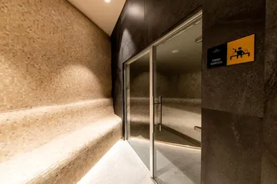 a hallway with a glass door in a building at Woodside Apartment 218 in Kopaonik