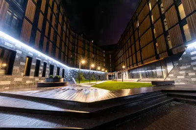 a building with a courtyard at night with lights at Woodside Apartment 218 in Kopaonik