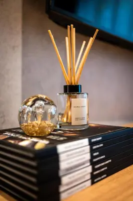 a stack of books with a glass bowl on top at Woodside Residence 325 in Kopaonik