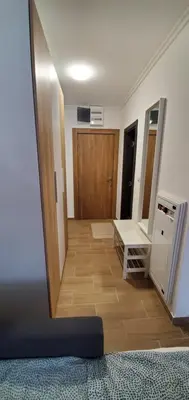 a room with a hallway with a door and a mirror at BelinaKop - Kopaonik Centar in Kopaonik
