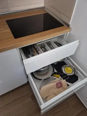 a drawer in a kitchen filled with dishes at BelinaKop - Kopaonik Centar in Kopaonik