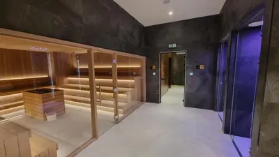 a dressing room with wooden cabinets and a hallway at Woodside apartments Kopaonik with garage in Kopaonik