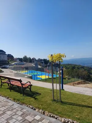 a park with a park bench and a playground at Mountain angel in Kopaonik