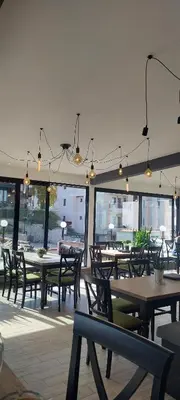 a dining room with tables and chairs and windows at Mountain angel in Kopaonik
