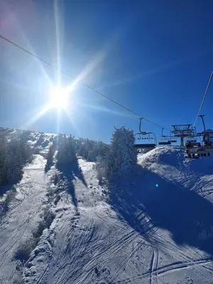 a person riding a ski lift on a snow covered slope at Mountain angel in Kopaonik
