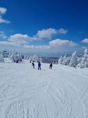 a group of people skiing down a snow covered slope at Mountain angel in Kopaonik