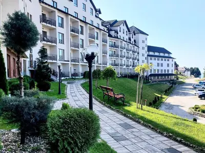 a park with a bench and a building at Mountain angel in Kopaonik