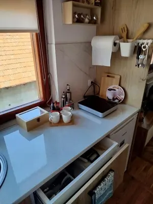 a small kitchen with a counter top with a counter top at Fina Apartman in Leskovac