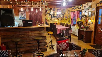 a restaurant with a bar and a table in a room at Odmaraliste Kod Miće Apartman 3 in Krušar