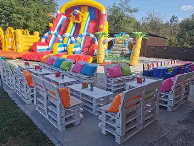 a group of tables and chairs in front of a play structure at Odmaraliste Kod Miće Apartman 3 in Krušar