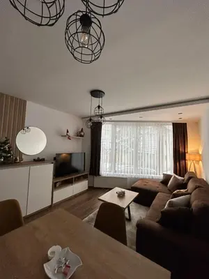a living room with a couch and a table at Garnet Star Apartments 1 in Kopaonik