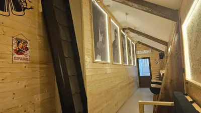 a hallway with wood paneling and pictures on the wall at Garnet Star Apartments 1 in Kopaonik