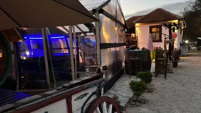 a food trailer with blue lights in front of a house at Vila Milica Poganovo in Poganovo