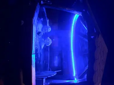 a dark room with a blue and green light at Vila Milica Poganovo in Poganovo
