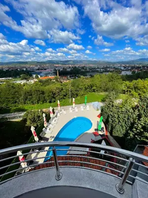 a view of a swimming pool from a balcony at Freya SPA Apartments in Niš