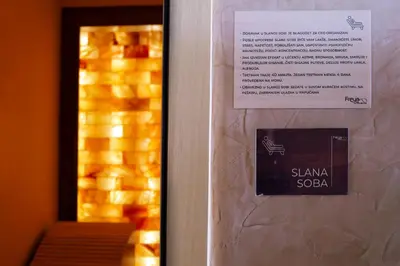 a sign on a door next to a mirror at Freya SPA Apartments in Niš