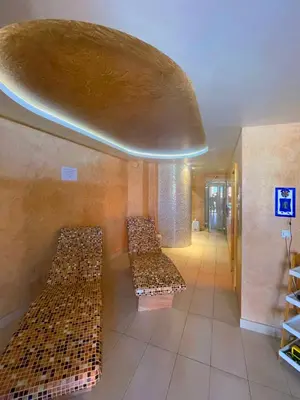 a room with three benches with a large ceiling at Freya SPA Apartments in Niš