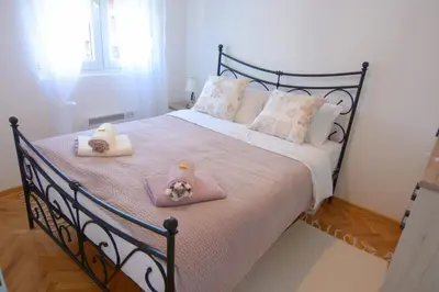 a bedroom with a bed with two towels on it at Apartman Provansa in Vrnjačka Banja