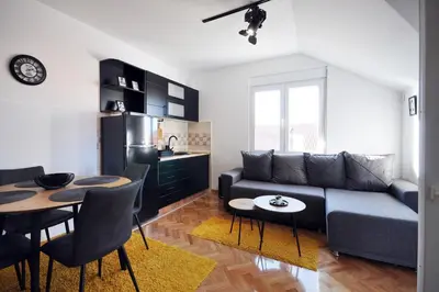 a living room with a couch and a table at Apartman Chaplin in Vrnjačka Banja
