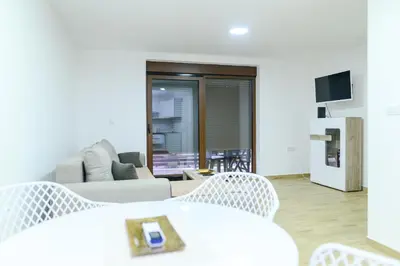 a living room with a couch and a table and chairs at Apartman Dina in Soko Banja