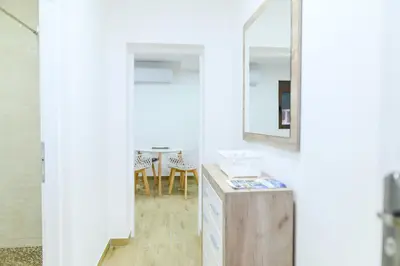 a bathroom with a mirror and a table at Apartman Dina in Soko Banja