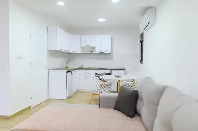 a living room with a couch and a table at Apartman Dina in Soko Banja