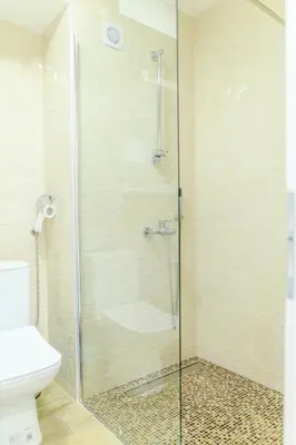 a shower with a glass door in a bathroom at Apartman Dina in Soko Banja