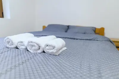 a bed with towels on top of it at Apartman Dina in Soko Banja