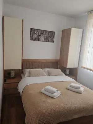 a bedroom with two beds with towels on them at Garnet Star Apartments, Kopaonik, apartman br 2 in Kopaonik