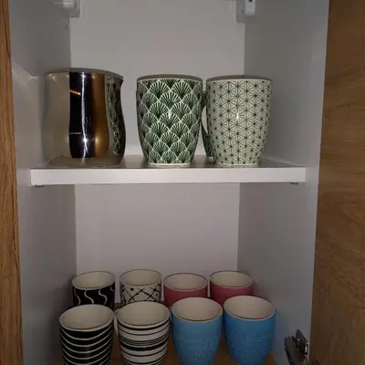 a group of vases sitting on a shelf at Garnet Star Apartments, Kopaonik, apartman br 2 in Kopaonik