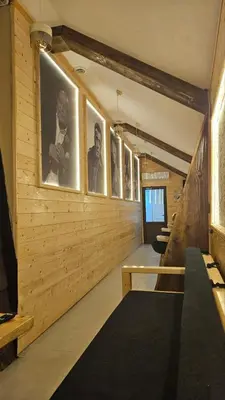 a row of framed pictures on the wall of a room at Garnet Star Apartments, Kopaonik, apartman br 2 in Kopaonik