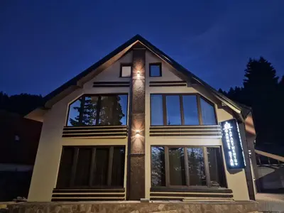 a house with lights on the front of it at Garnet Star Apartments, Kopaonik, apartman br 2 in Kopaonik