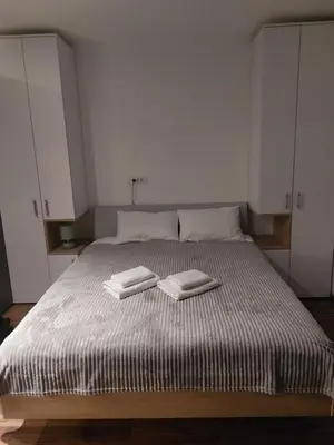 a bedroom with a bed with two towels on it at Aparmani Sorak Kopaonik, Studio Apartman A5 in Kopaonik