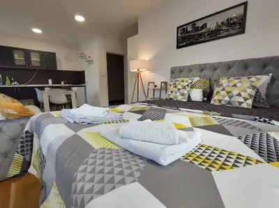 a bedroom with a bed with towels on it at Apartman Natura in Vrnjačka Banja