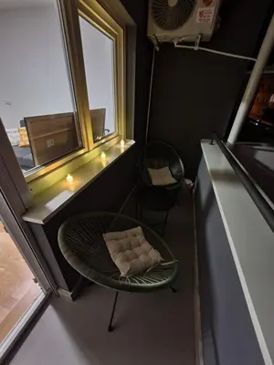 a small room with a chair and a window at Apartman Natura in Vrnjačka Banja