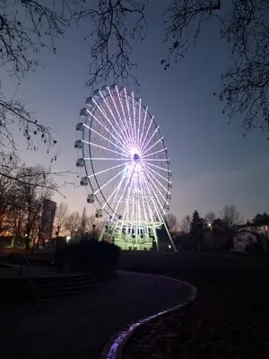 a ferris wheel in a park at night at Apartman Natura in Vrnjačka Banja