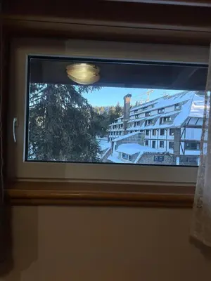 a window with a view of a building at Apartman 601 i 603 Kopaonik Centar in Kopaonik