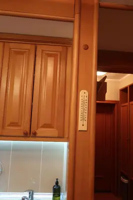 a kitchen with wooden cabinets and a sink at Apartman 601 i 603 Kopaonik Centar in Kopaonik