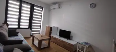 a living room with a couch and a flat screen tv at LaNe apartman Sokobanja in Soko Banja