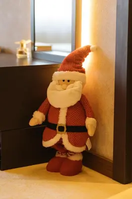 a santa claus toy is leaning against a wall at Woodside TEA Residences & SPA Kopaonik in Kopaonik
