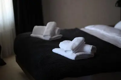 a group of towels sitting on top of a bed at Woodside TEA Residences & SPA Kopaonik in Kopaonik