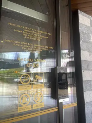 a window of a building with a sign on it at Woodside TEA Residences & SPA Kopaonik in Kopaonik