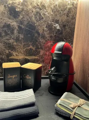 a close up of a toaster and some towels at Woodside TEA Residences & SPA Kopaonik in Kopaonik