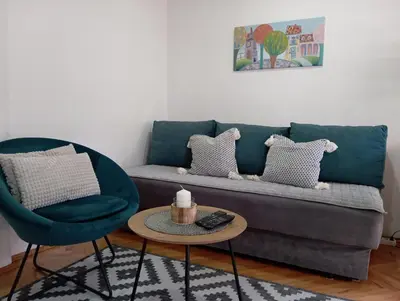 a living room with a couch and two chairs at Apartman Kosta in Leskovac