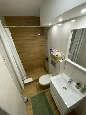 a bathroom with a white sink and a toilet at Apartman Kosta in Leskovac