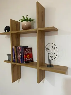 a book shelf with books and a lamp on it at Apartman Kosta in Leskovac