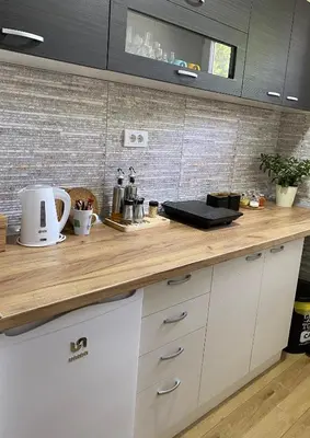 a kitchen with a wooden counter top in a room at Apartman Kosta in Leskovac