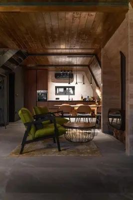 a living room with a green couch and a table at V house Goc in Miodragoviči