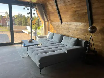 a living room with a couch and a table at V house Goc in Miodragoviči