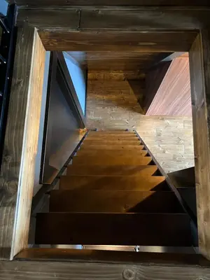a view of a staircase in a building with wood at V house Goc in Miodragoviči